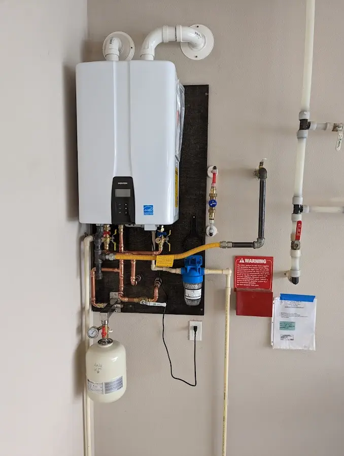 Professional plumber installing copper piping in a Cupertino home